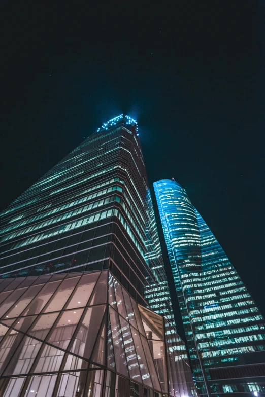 a close up of two tall buildings at night