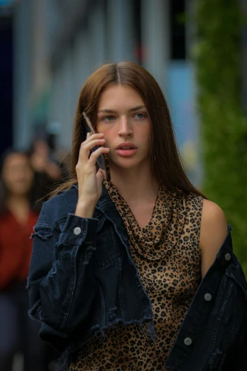 a girl talking on the phone while holding a cell phone to her ear