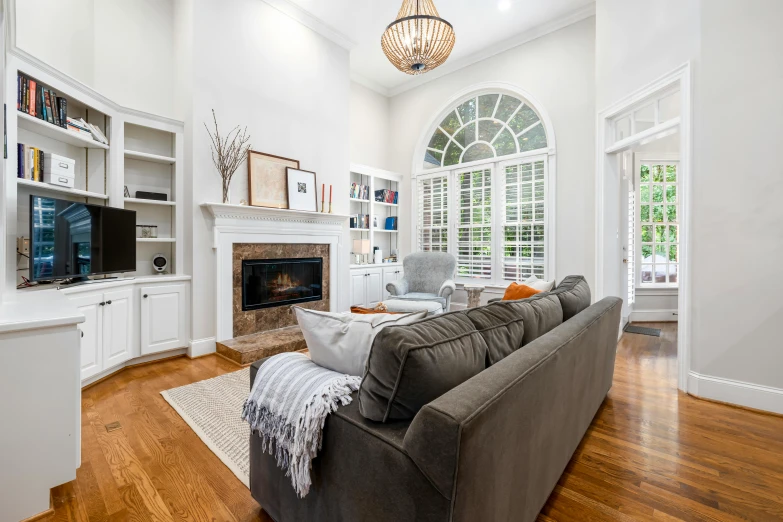 a living room with white walls and a fireplace