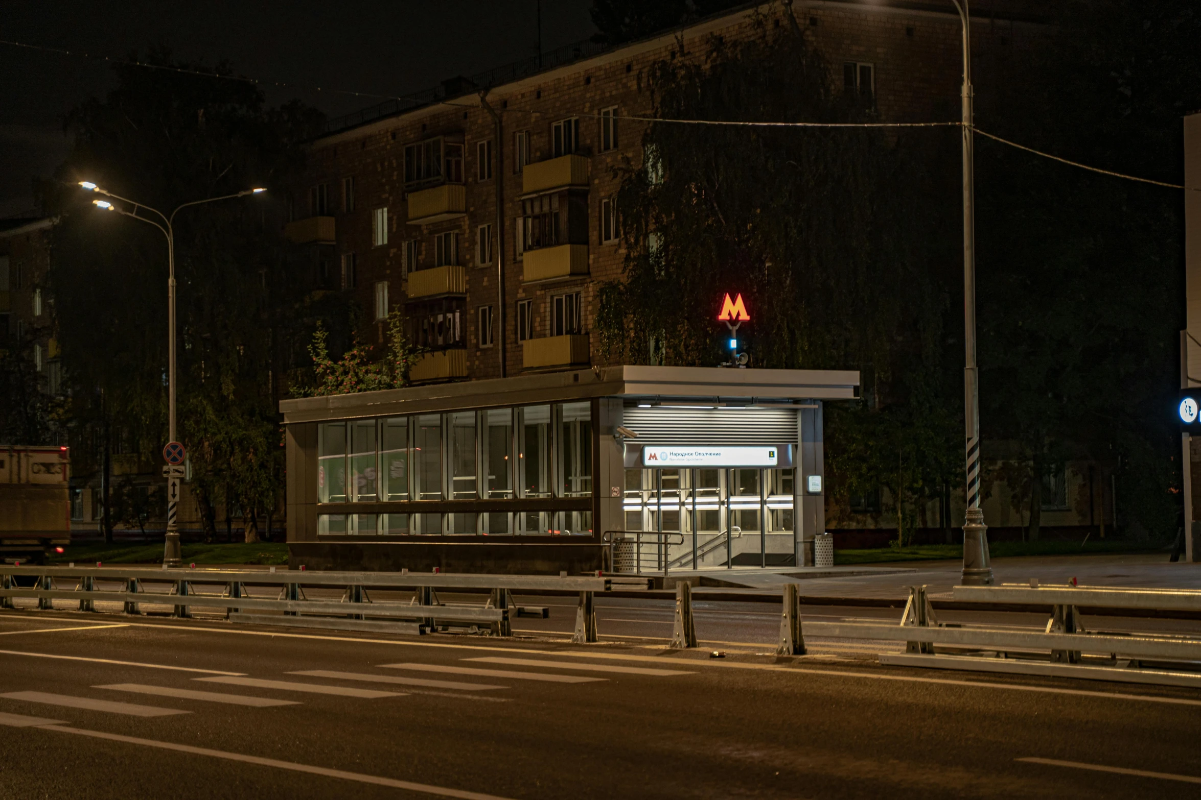 the streetlight shines on a city street corner