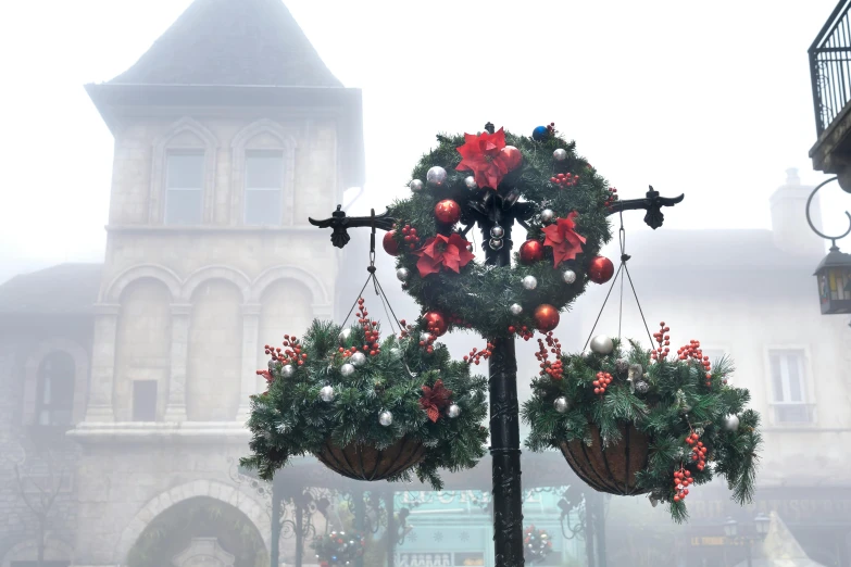 an image of a clock tower decorated for christmas