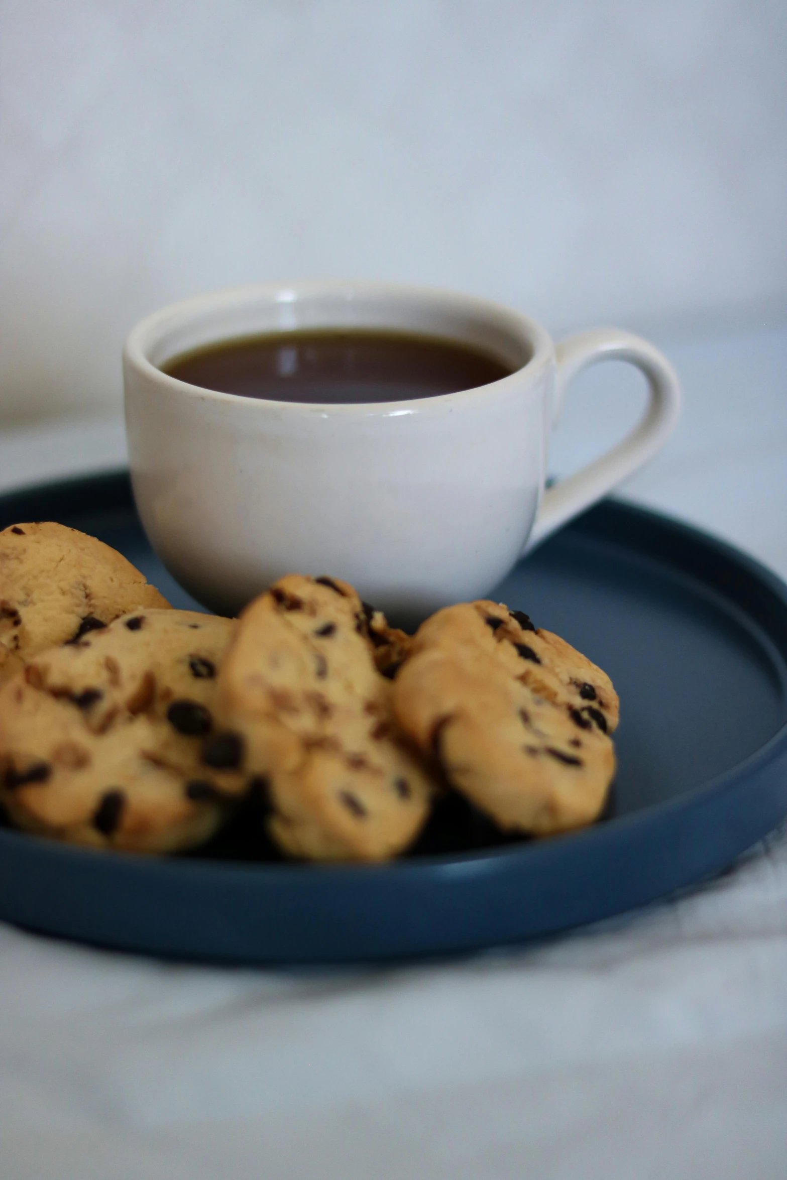 two plates with cookies and a cup of coffee on a plate