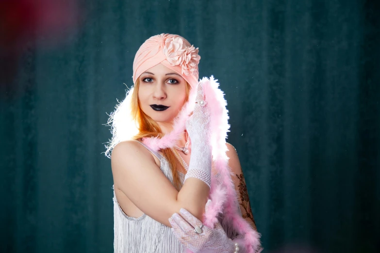 a woman with bright pink feathers on her head, standing in a pose