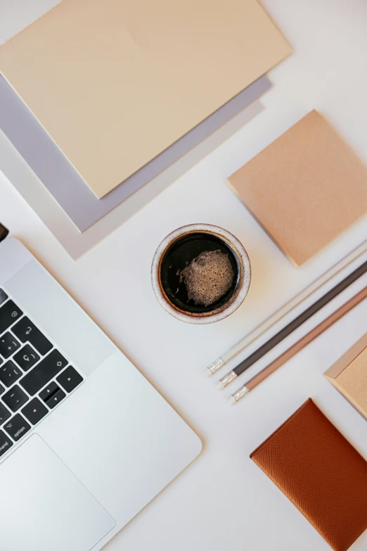 laptops, papers and accessories arranged on a desk