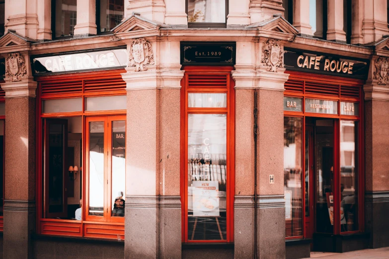 a building with orange windows and red trim