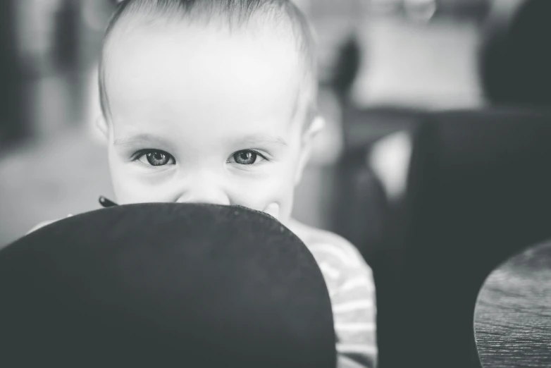 a close up of a young child with a hat