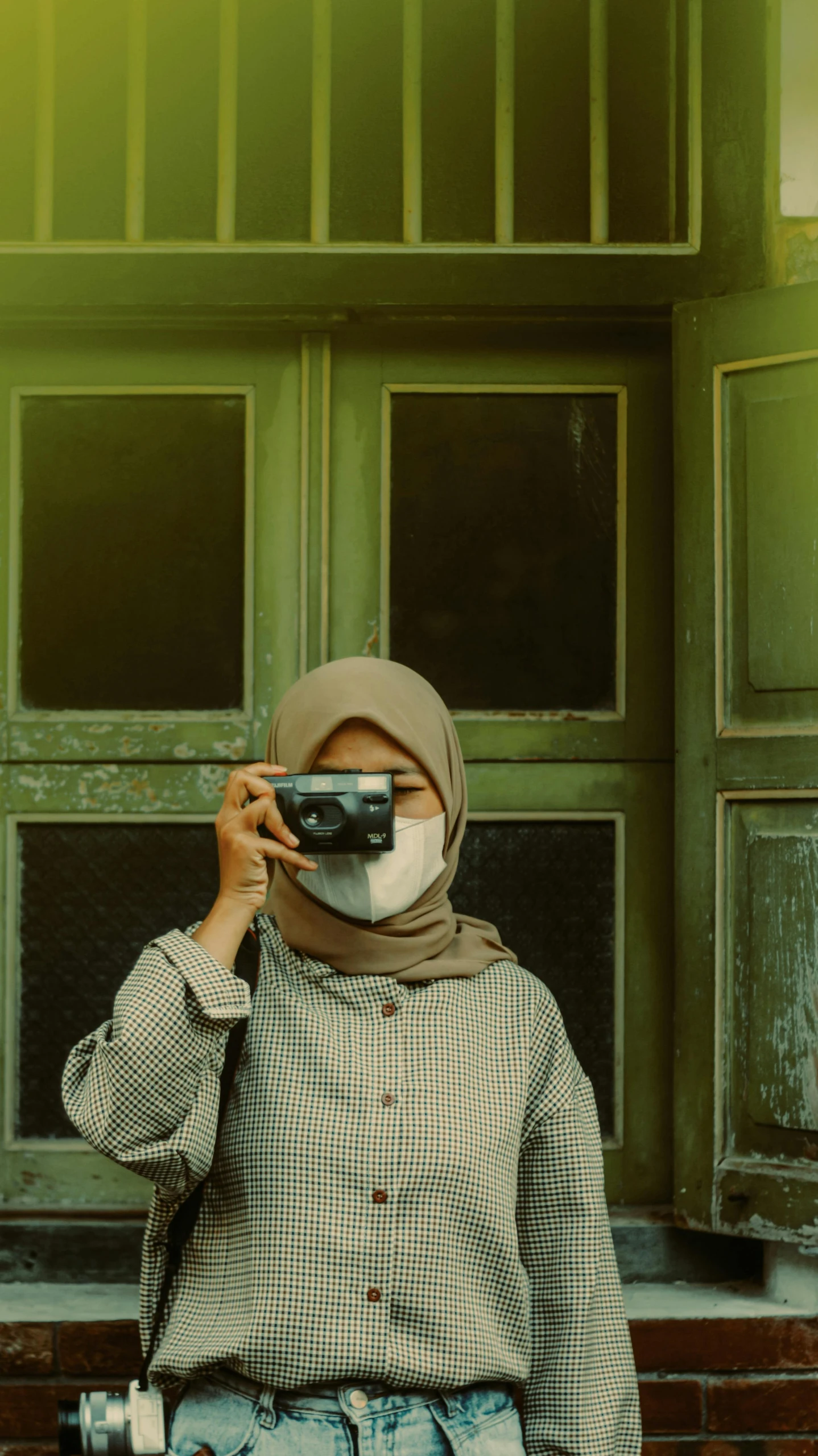 a woman is sitting outside taking a selfie