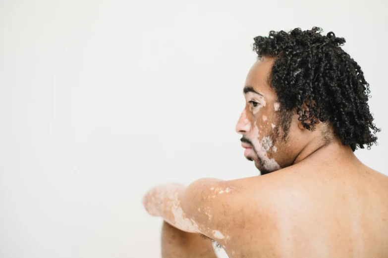 a man washing his hair and neck with foam