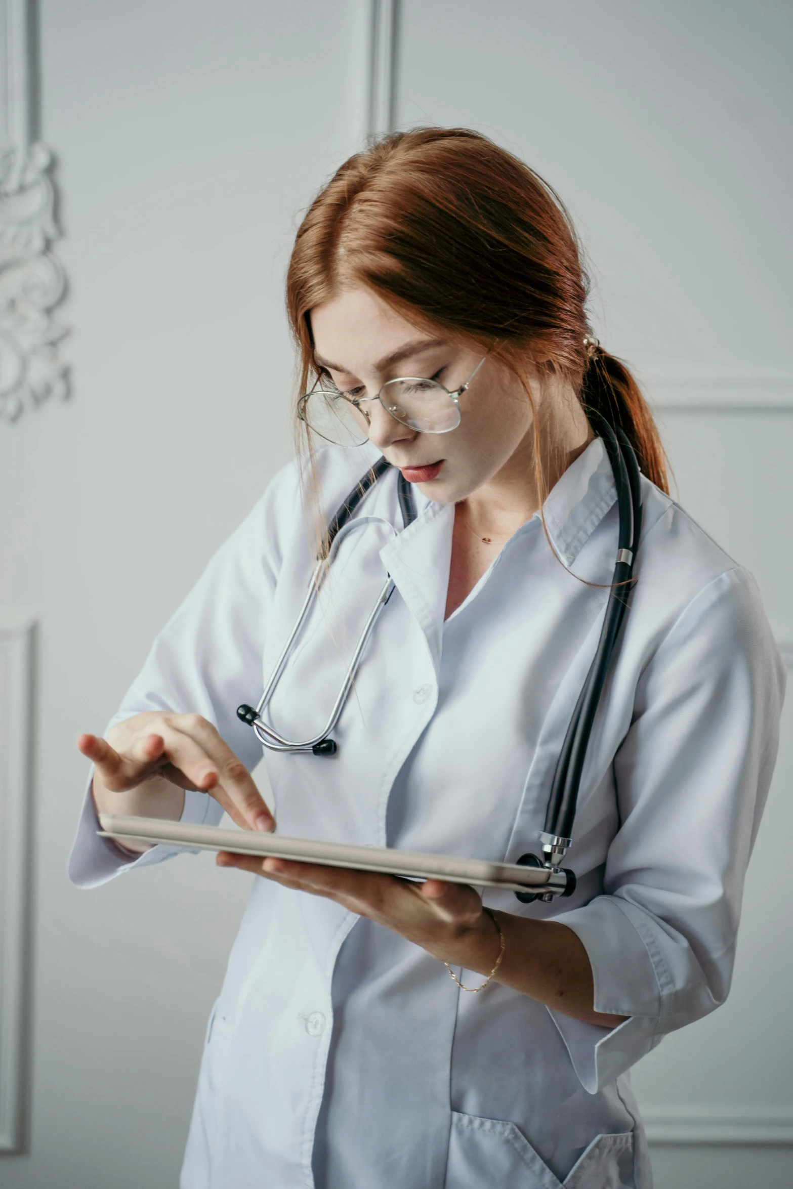 a female doctor is writing on a note pad