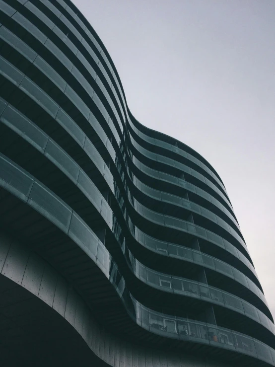 the side of a tall modern building with many windows