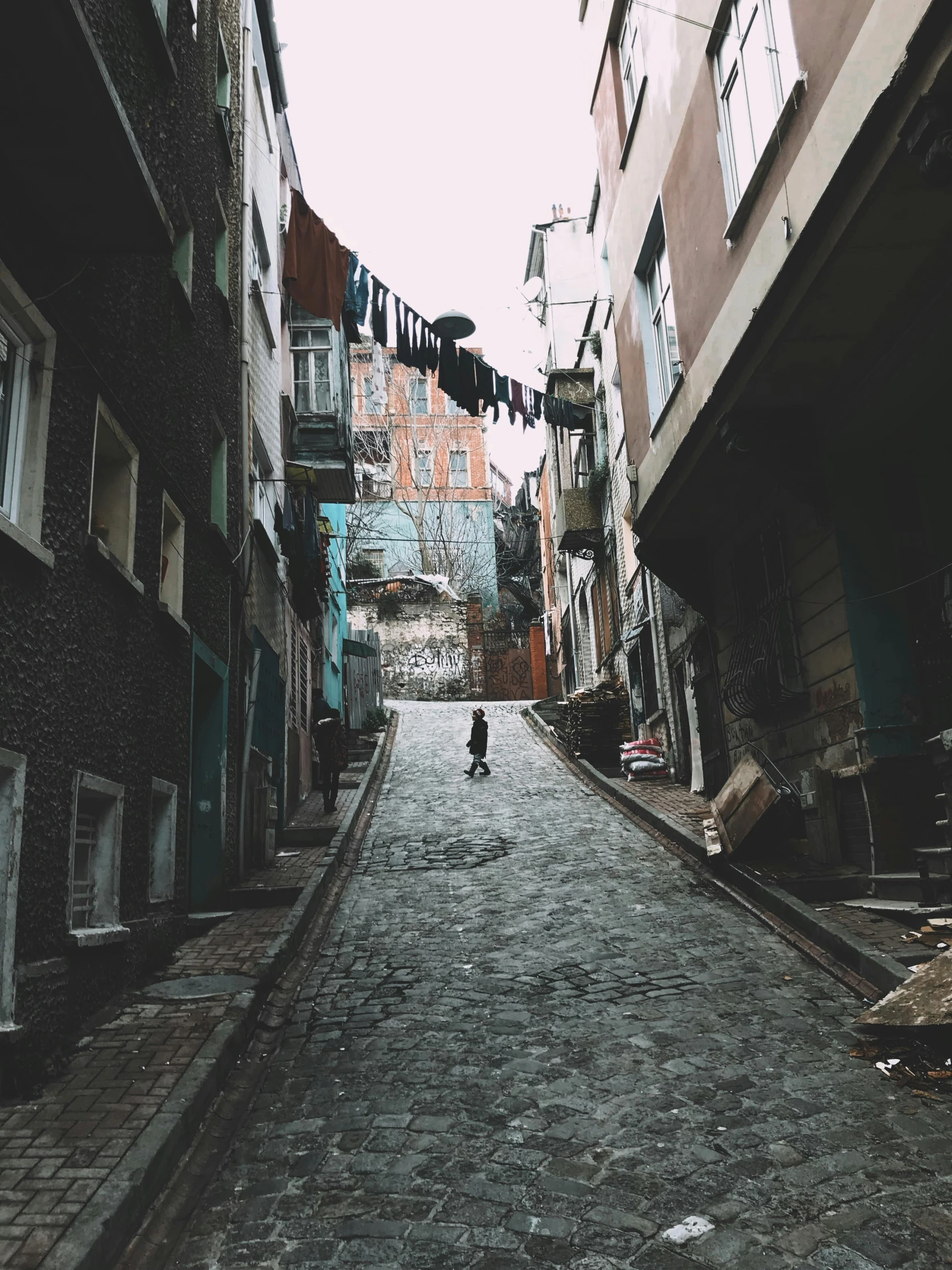 a person is standing alone in a quiet alley way