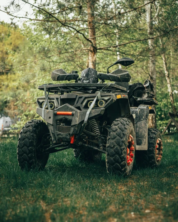 a person drives a small atv in the forest