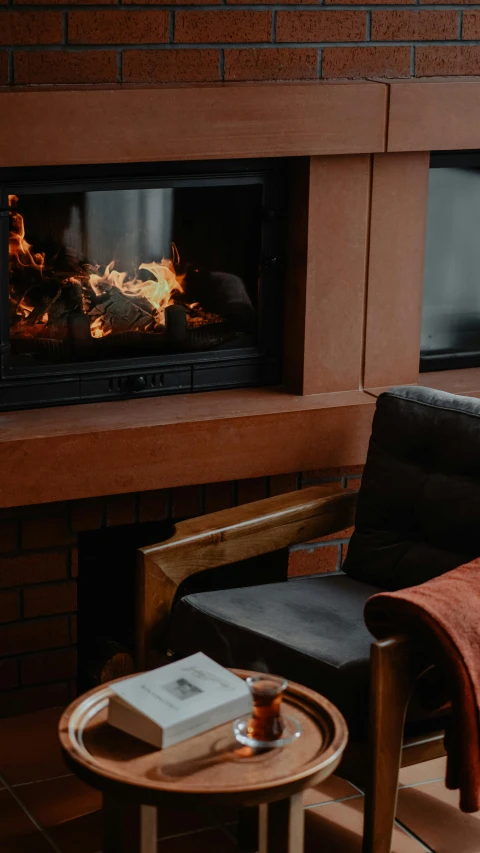 a living room with a fireplace filled with fire and a couch