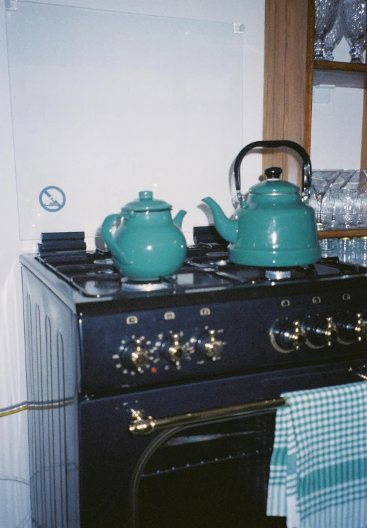 two teapots are on top of the stove