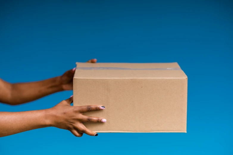 there is a hand reaching out from a box