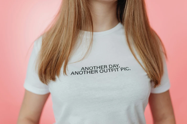 a woman with long hair wearing a t - shirt reads another day another cutie pic