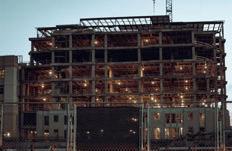 a tall building with lots of windows under a crane