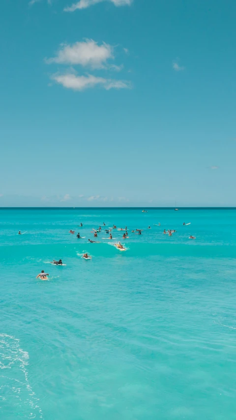 a large body of water with swimmers and no surfboards