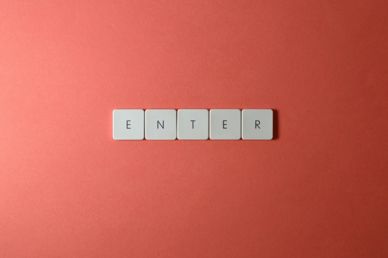 letters written in white color made up of tile letters on a red background