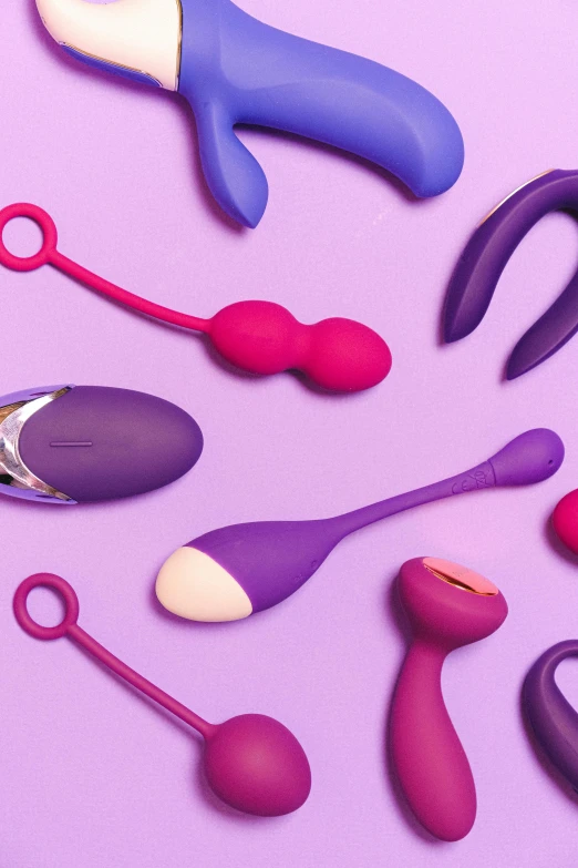 various types of scissors on purple surface