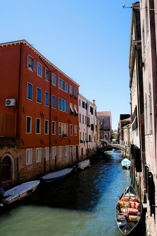 a boat is parked on a river near some buildings