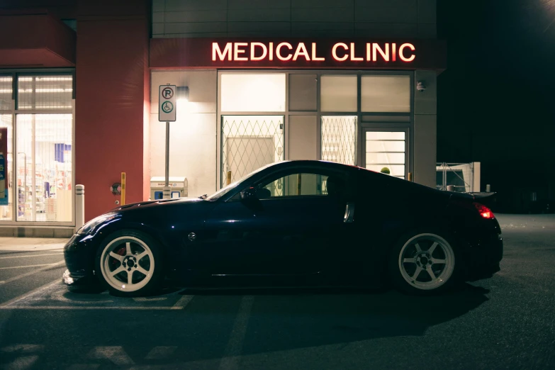 a dark car parked outside a medical clinic