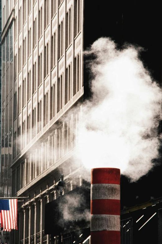 a street light is shown with a cloud of smoke coming out of it