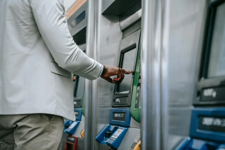 a man entering a subway train with his hand on the electronic key