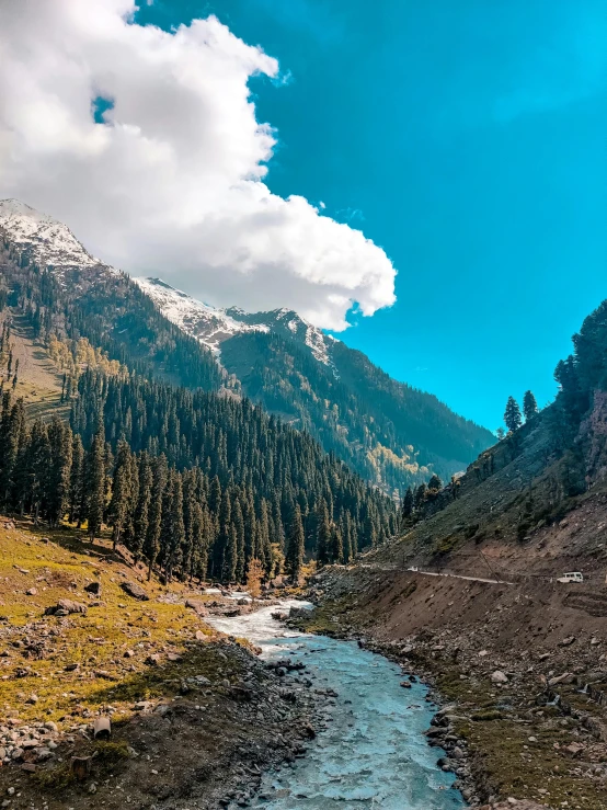 a stream flows through the valley in mountains