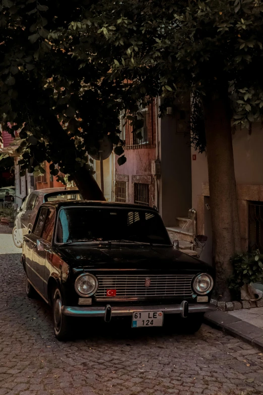 an old car parked on a city street