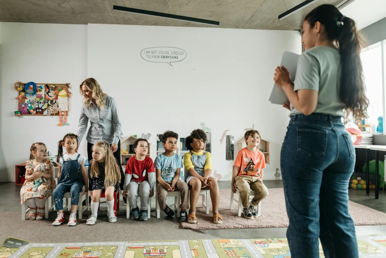 a teacher is reading to a group of children