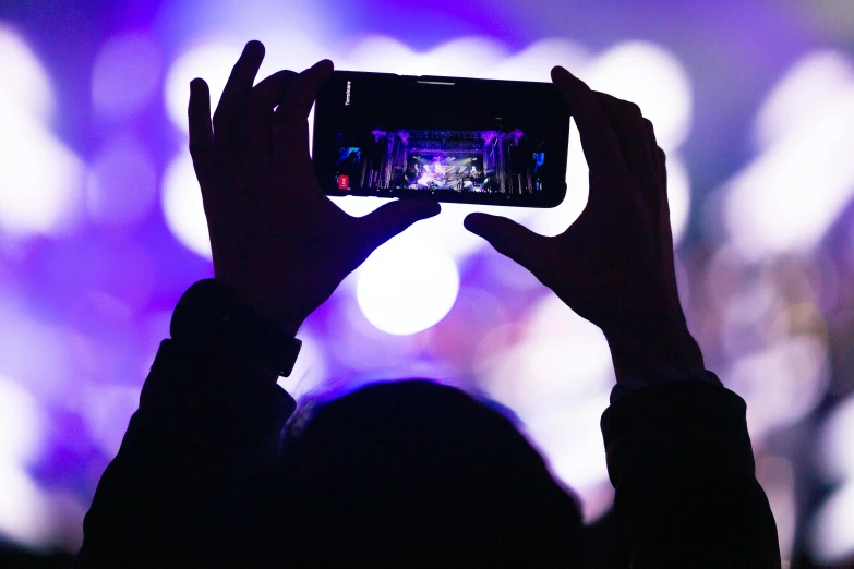 a woman taking a po with her cell phone