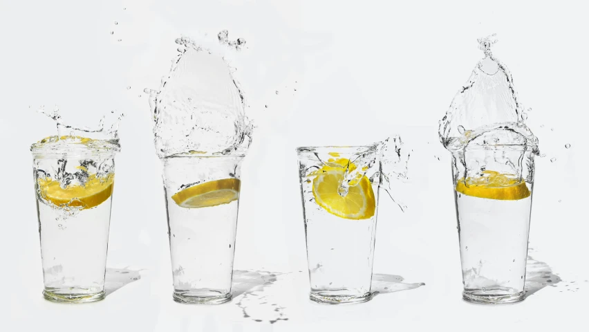 three glasses filled with lemons, water and ice