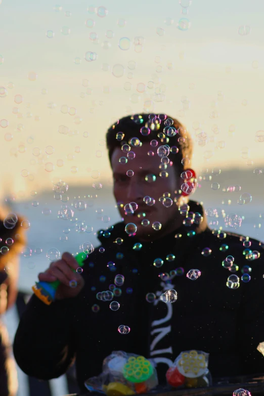 a man with soap bubbles on his face and hands in front of him