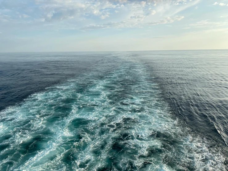 the back of a large boat traveling through the open ocean