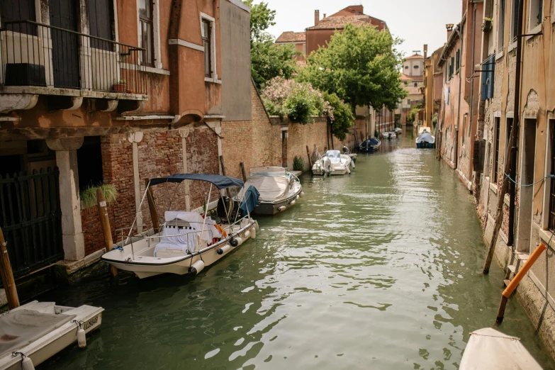 a couple boats are parked on the side of a river