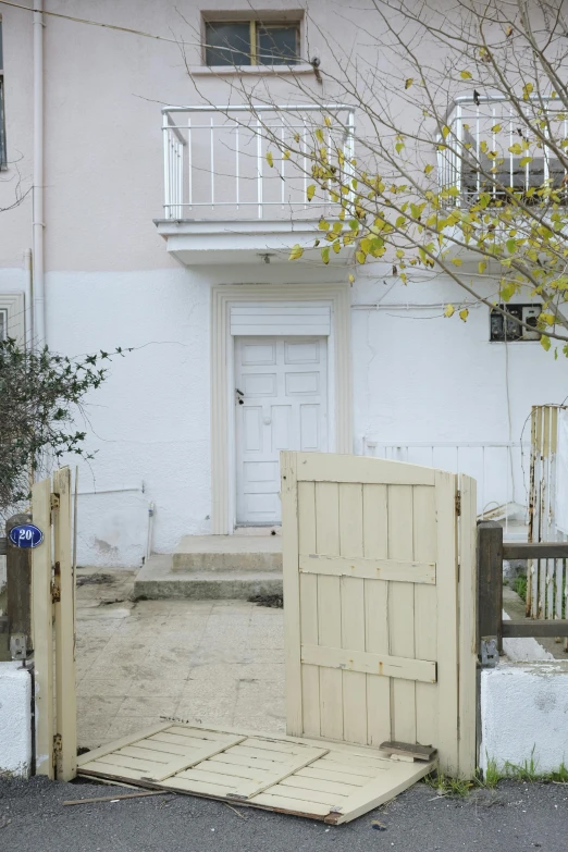 an entrance to a house with a wooden gate