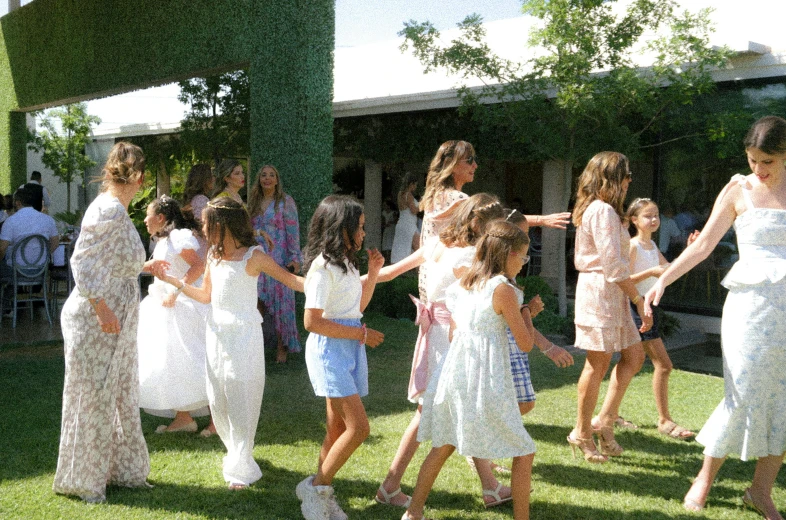 a large group of people dressed in long dresses