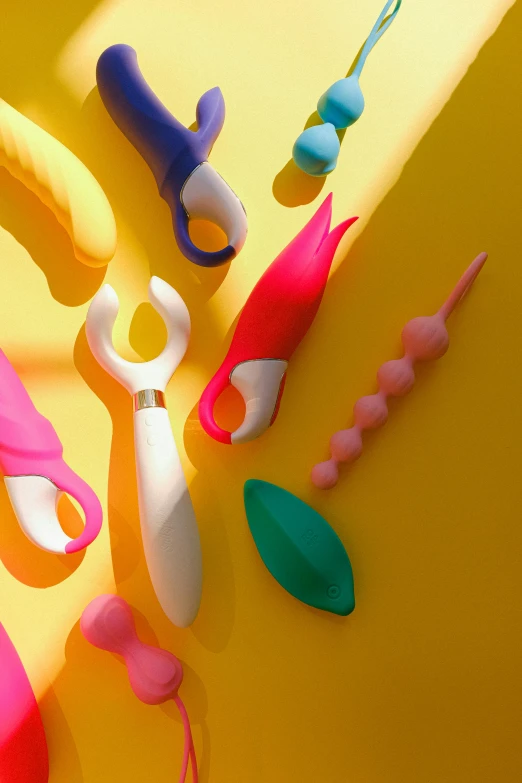 a pair of scissors next to different colors and shapes