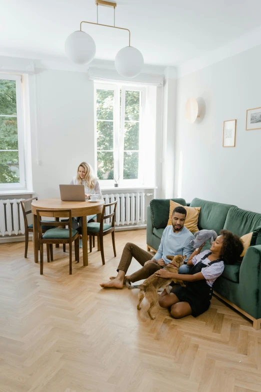 a group of people sitting on a couch in front of a computer