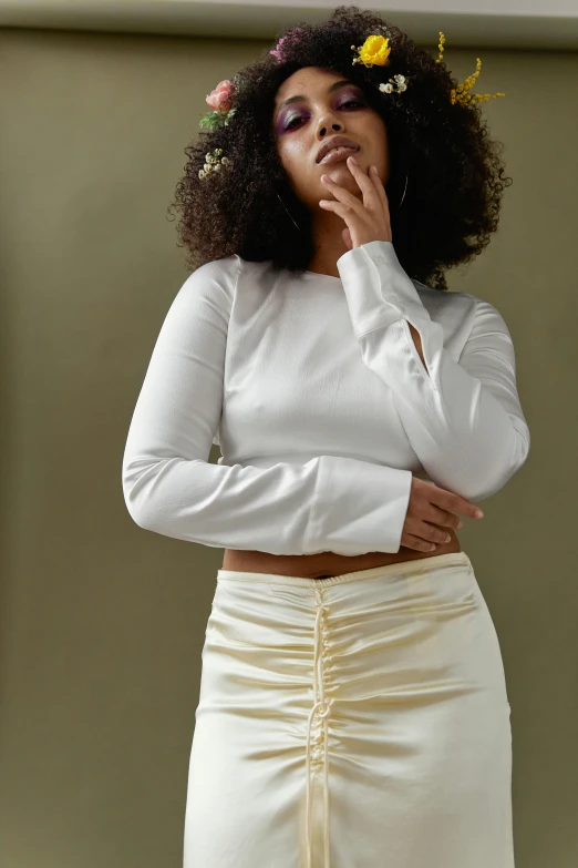 woman with natural makeup poses in white dress