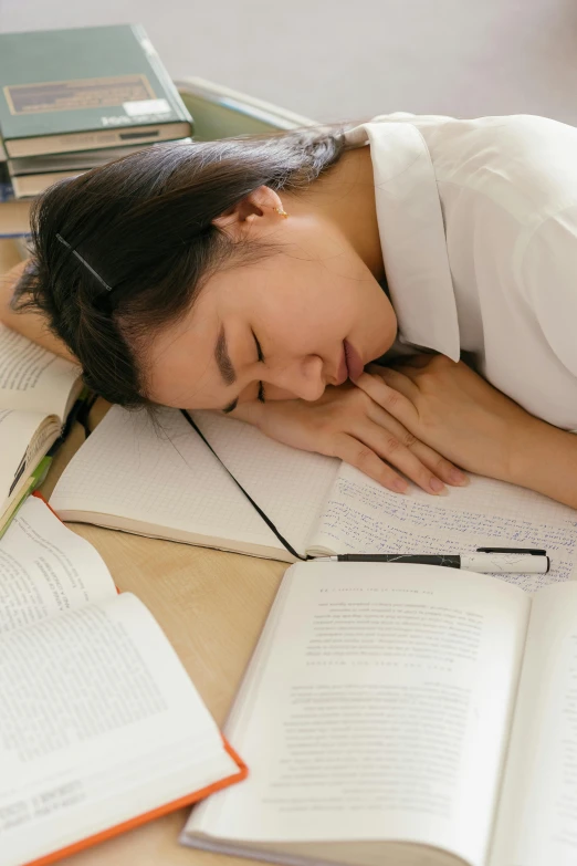 a girl taking a nap on her homework