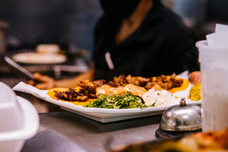 a table with food that includes fried potatoes and vegetables