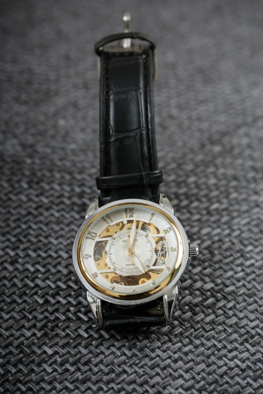an open watch with the face of a human skeleton printed on it