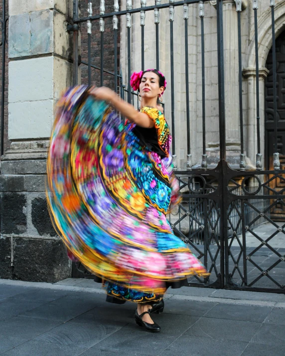 there is a woman that is dancing on the street