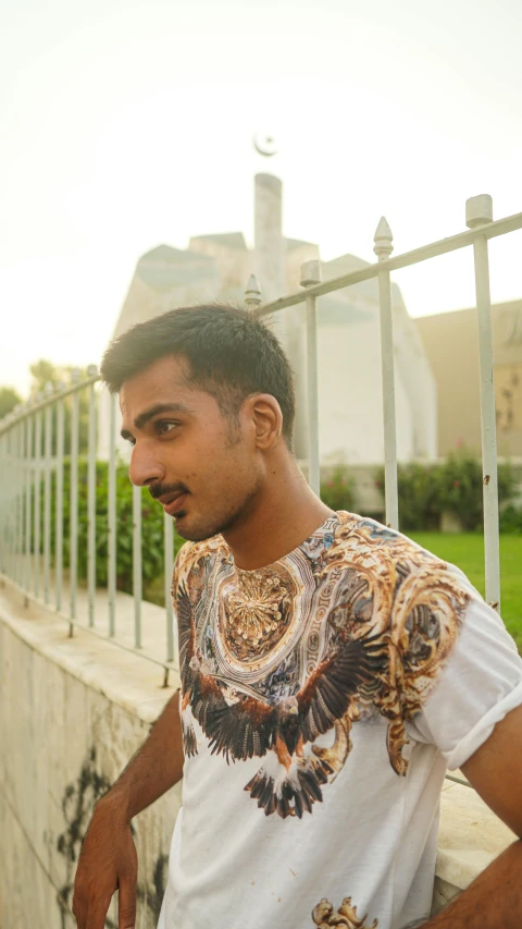 a man looks at the camera wearing a decorative t - shirt