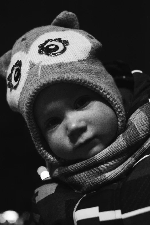 a baby with a winter hat and scarf on