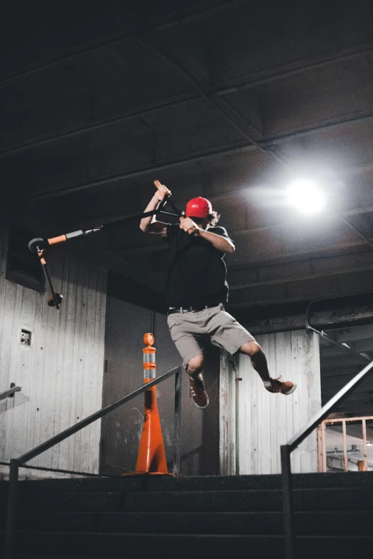 a man holding on to his baseball bat doing a trick