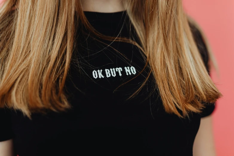 a blonde woman wearing a black shirt that reads ok but no