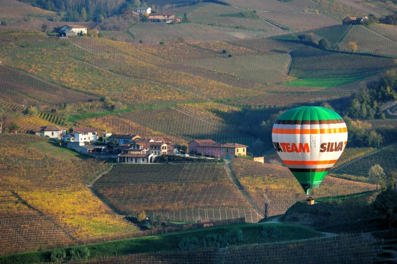  air balloons in the sky near some houses